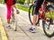 Bikes bicyclist girl. Children feet and bicycle wheel. Low section.