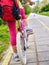 Bikes bicyclist girl. Children feet and bicycle wheel. Low section.