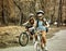 Bikes girls with rucksack cycling on bicycle. Toned sepia image.