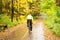 Biking in colorful autumn park during rain