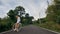 Biking road trip. The woman on blue bike in white clothes on forest road. The girl ride on bicycle. Cycling Cycle Fix