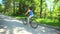 Biking woman cycling on bike. Sporty woman riding bicycle in summer day. Female cyclist outdoor activity living healthy