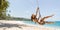 Bikini Beach Girl Model in Black Swimsuit on Palm Tree Swing on Tropical Sea Shore During Summer Vacations