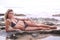 Bikini girl lying on a seaside rock