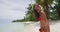 Bikini travel woman walking on beach smiling and laughing at camera on Bora Bora