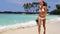 Bikini woman happy having fun on tropical beach with snorkel fins and mask