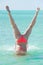 Bikini woman underwater handstand ocean