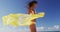 Bikini woman with yellow scarf unveiling toned slim thighs and body. Spa wellness free happy girl in bikini weight loss