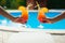 Bikini women in pool relaxing with juice, young beautiful girls resting in vacation on summer season at swimming