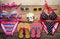 Bikinis, sunglasses, shoes, two sets placed on a wooden floor.