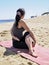 Bikram yoga arda matsyendrasana pose at beach