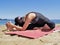 Bikram yoga janushirasana pose at beach