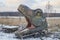 Bila Tserkva, Ukraine, January, 2020: Abandoned huge head of decorative dinosaur on winter lawn