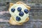 Bilberry mini tart with cheese on old wood table