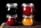 Bilberry, strawberry, orange and raspberry jams in glass jars