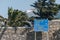 Bilingual directional sign on a road in Mykonos, Greece