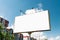 Billboard, billboard, canvas billboard, layout against the blue sky. The concept of outdoor advertising, marketing, sales. mockup