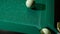 Billiard balls on a billiard table with green cloth roll in different directions from a strong blow with a cue. Ball in