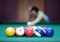 Billiard balls and blurred woman in the background