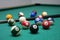Billiard balls and a cue in a leisure club environment, lots of billiards on the table, wallpaper background