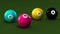Billiard balls on a green background with letters CMYK.