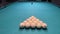 Billiard balls are laid out in the shape of a triangle on a green table of Russian billiards. Ivory balls