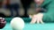 Billiard balls roll on the green table