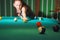 Billiard balls on table, blurred silhouette of cue