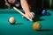 Billiard balls on table and cue aimed