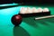 Billiard balls, triangle rack and cue on table