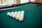 Billiard balls and two Cues in the form of a triangle on the billiard table are ready for the game.