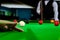 Billiard cue of professional snooker player closeup aiming shot white ball