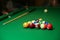 Billiard cues and pyramid of multicolored pool balls