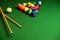 Billiard cues and pyramid of multicolored pool balls