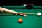 billiard green table in hall with white balls with men hand