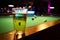 a billiard parlor on the rail of a pool table is a glass with a beer