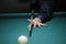 Billiard player arm breaking the pyramid by striking the ball with cue stick