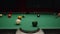 Billiard player hits a green ball with a white cue ball with a cue close up, but it does not fall into the pocket. Man