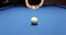 Billiard player's hands move and align pyramid of balls forward and white ball