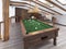 Billiard room in the attic with sitting area and fireplace.