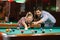 Billiard- smiling couple shooting pool ball