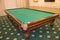 Billiard table with green baize stands in a luxurious living room, a concept of sports and Hobbies for the wealthy