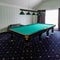 Billiard table in the hotel, sports game for relaxation.