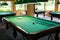 Billiard tables in the room without people, with lighting