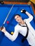 Billiard young man player lying on pool blue table