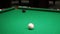 Billiards. Close-up of someone aiming the billiard ball with cue. Billiards game