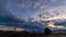 Billowing Clouds Over A Field 