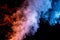 Billowing Plume of Red and Blue Smoke on Top of a Black Background