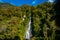 Billy Falls with the Glacial Blue river water flowing over rocks. Haast Pass, South Island, New Zealand