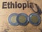 Bimetallic coins - a recent issue of 1 birr of Ethiopia on a wooden table on which the name `Ethiopia` marked